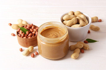  peanut butter and peanut beans on wooden background