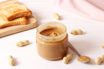 Obraz na płótnie Canvas peanut butter and peanut beans on wooden background