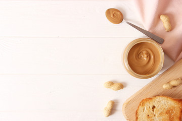  peanut butter and peanut beans on wooden background