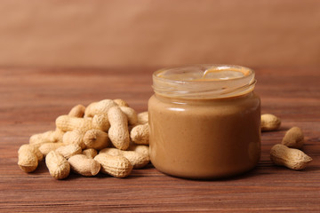 peanut butter and peanut beans on wooden background