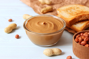  peanut butter and peanut beans on wooden background