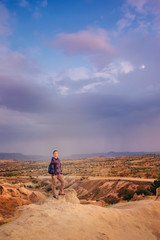 Tourist woman enjoy sunset mountain view in Cappadocia