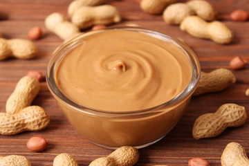  peanut butter and peanut beans on wooden background