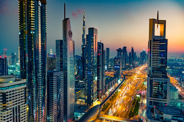 Beautiful skyline with skyscrapers at night during blue hour in Dubai