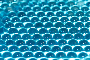 Fototapeta premium Water blue gel balls. Polymer gel. Silica gel. Balls of blue hydrogel. Crystal liquid ball with reflection. Texture background. Close up macro
