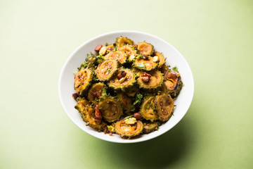 Cooked bitter Melon/gourd or Karela Sabzi served in a bowl. Scientific name of this healthy...