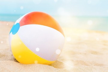 Obraz premium Background with a beach ball in the sand