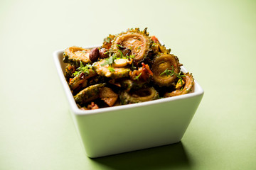 Cooked bitter Melon/gourd or Karela Sabzi served in a bowl. Scientific name of this healthy vegetable is Momordica charantia. selective focus