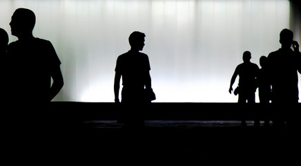 Silhouettes of young  people walking in motion blur in the night