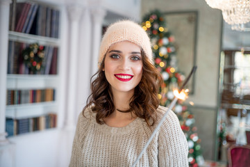 happy young woman is celebrating christmas at home