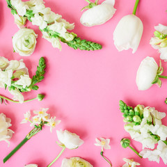 Floral frame with white flowers on pink background. Flat lay, top view.