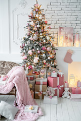 Christmas living room with a christmas tree and presents under it