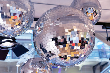 Mirror disco balls and a searchlight on a New Year's background.