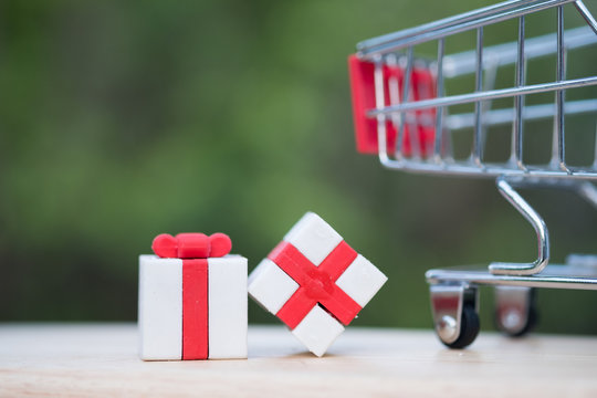 Wrapped Christmas gifts with shopping cart backgroud