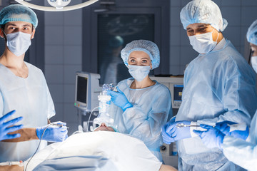 Concentrated Surgical team operating a patient in an operation theater. Well-trained...