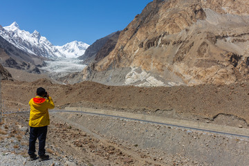 Photographer take photo at Passu Glacier. Karakorum region. Passu Peak is situated in the back side of the glacier.Northern Pakistan.