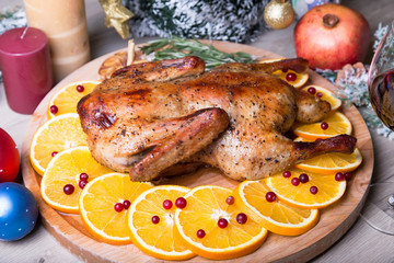 Christmas duck with oranges and cranberries whole baked. Close-up, selective focus.