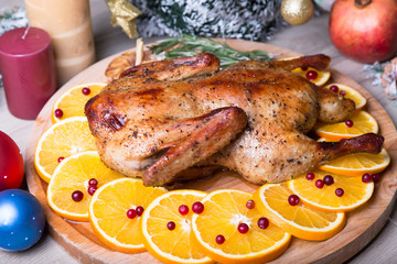 Christmas duck with oranges and cranberries whole baked. Close-up, selective focus.