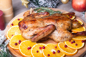 Christmas duck with oranges and cranberries whole baked. Close-up, selective focus.