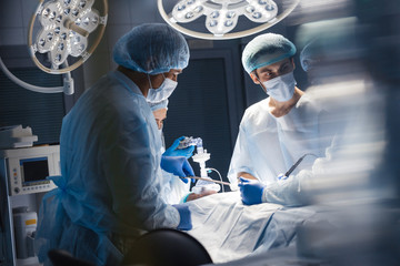 Operation room surgery in hospital, blurred figures. Professional treatment and professional...