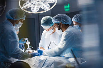 Operation room surgery in hospital, blurred figures. Professional treatment and professional...