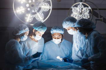 Hospital concept. Surgery team looking at camera in the operating room in a hospital clinic while...