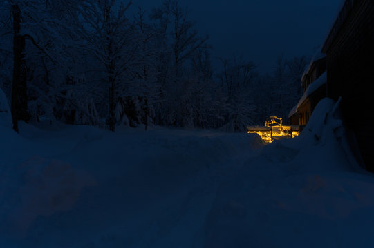 Lighted Chairlift on a Snowy Porch in Maine