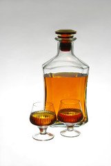 Strong drinks. Glass of cognac and bottles