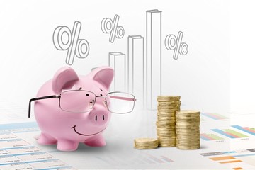 Pink piggy bank in glasses on background