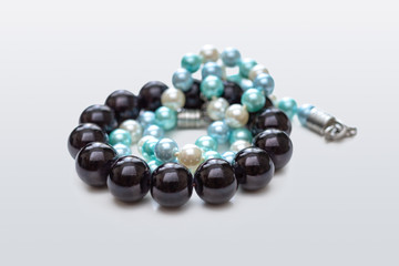 Black bracelet and white and blue necklace