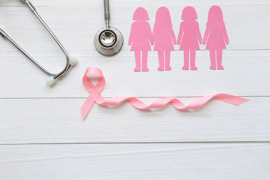 Pink ribbon and stethoscope on white wooder background, Symbol of breast cancer in women, Health care concept