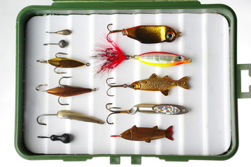 Fishing spoons for winter fishing on white.