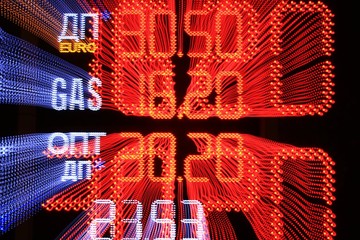 Board prices at the gas station in Ukraine. Abstract background of blurry colorful of motions LED lights.