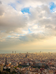 panorama of Barcelona at sunset in the rays of the sun coming out of the clouds