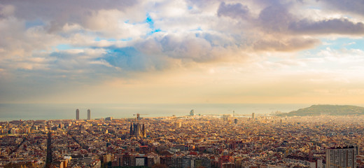 Fototapeta premium panorama of Barcelona at sunset in the rays of the sun coming out of the clouds