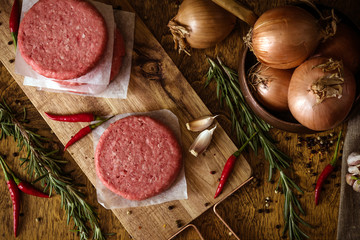 Raw beef burger, traditional barbecue, still life with vegetables and meat
