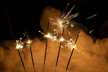 Christmas sparkler isolated on black background. Bengal fire