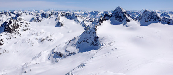 winter mountain landscape in the Silvretta mountain range in the Swiss Alps with famous Piz Buin mountain peak in the center