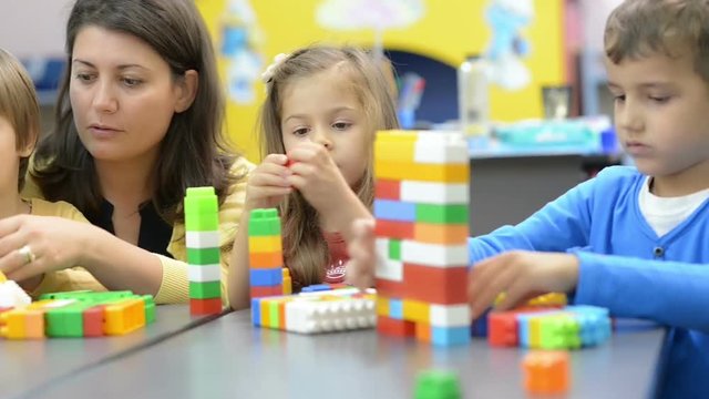 Kids and Educator Playing at Kindergarten