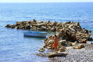 Fototapeta na wymiar beautiful girl at the sea Bay with boats