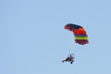 A colorful Para Plane floats through the sky