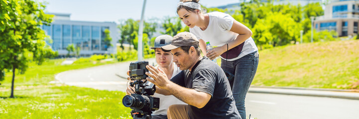 a cameraman operator discuss the shooting process with a director and dp BANNER, LONG FORMAT