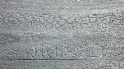 Black wood surface with cracks, natural patterns