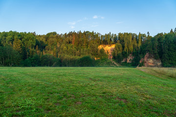 empty countryside landscape in autumn with fields and meadows and rare trees in background