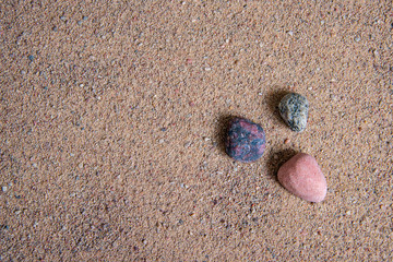 relaxing stones laying on sand textured pattern