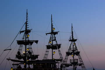 abstract romantic Caribbean sea concept landscape with vintage ship mast dark silhouettes in...