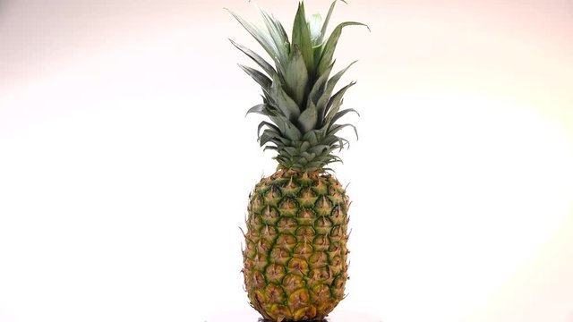 Fresh pineapple spinning on white background, Turntable