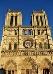 Fototapeta na wymiar Notre Dame Cathedral, facade with sunset light. Paris, France, sunny day, blue sky.