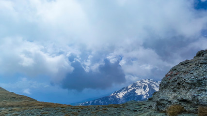 Top of the mountain view of the mountain peaks and valley covered in snow