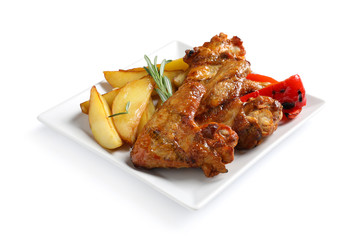 Plate with barbecued chicken wings and garnish on white background